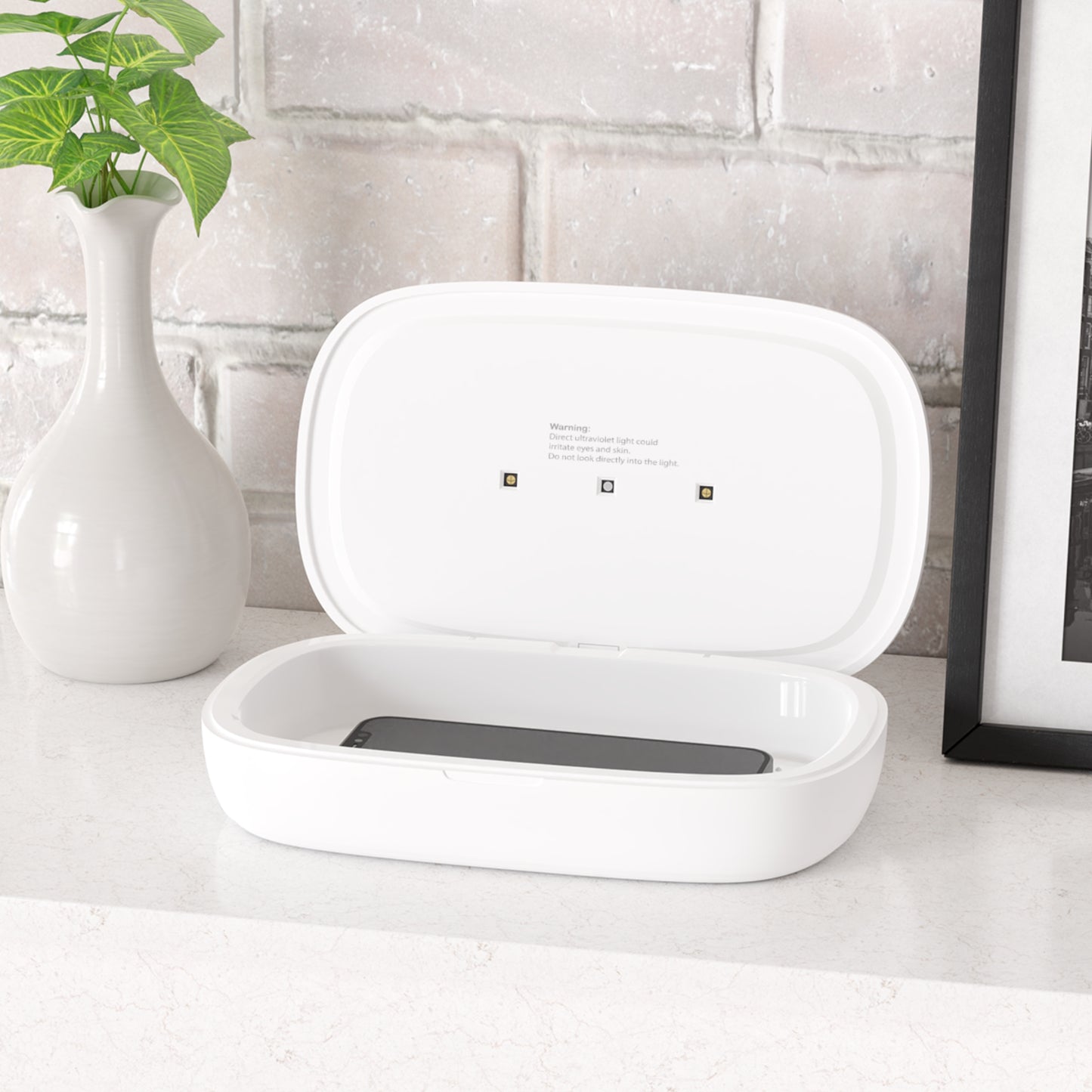 UV Phone Sanitizer and Wireless Charging Pad with Urban Halo Design